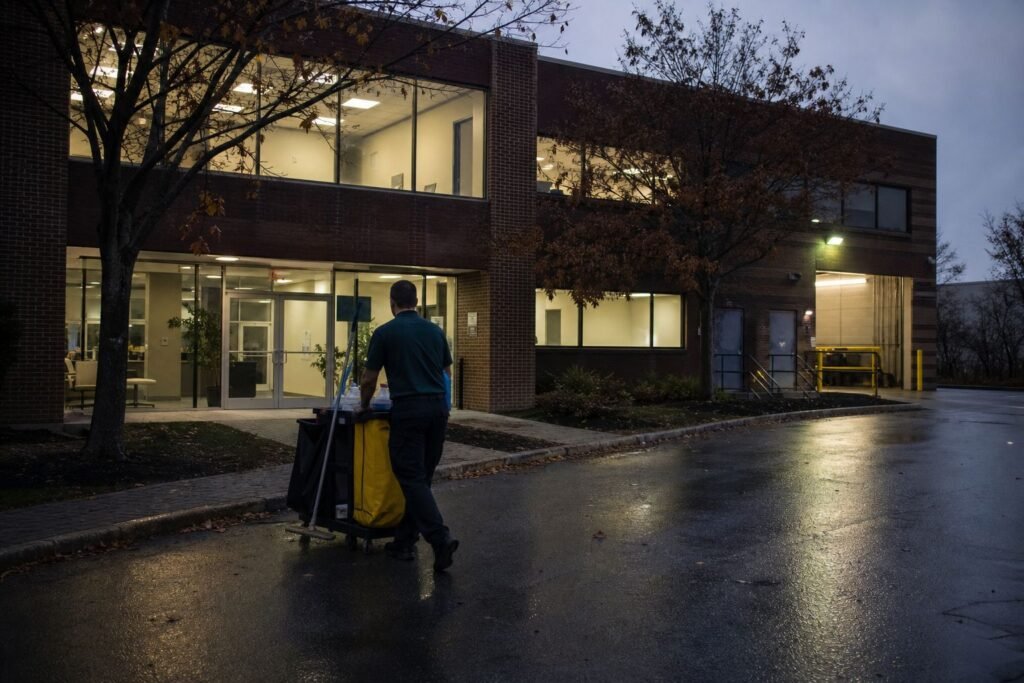 Cleaner arriving at a flex office and warehouse building at dusk